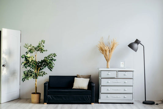 Gallery wall arrangement with framed art prints and photographs in matching frames